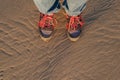 Human in trekking boots on a wet sand Royalty Free Stock Photo