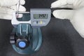 Human use digital micrometer measurement a red ball probe