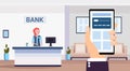 Human using banking mobile application specialist at reception counter financial consulting center reception modern bank