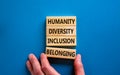 Humanity, diversity, inclusion, belonging symbol. Wooden blocks with words humanity, diversity, inclusion, belonging on beautiful Royalty Free Stock Photo