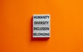 Humanity, diversity, inclusion, belonging symbol. Wooden blocks with words humanity, diversity, inclusion, belonging on beautiful Royalty Free Stock Photo