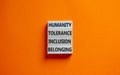 Humanity, tolerance, inclusion, belonging symbol. Wooden blocks with words humanity, tolerance, inclusion, belonging on beautiful Royalty Free Stock Photo