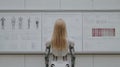 Humanoid robot analyzing technical schematics in a research lab. Advanced robotics, artificial intelligence, human-robot