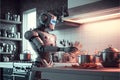 A humanoid robot as a cook preparing a meal in the kitchen