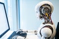 Humanoid robot working on computer using keyboard in office. Royalty Free Stock Photo
