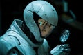Humanoid robotic detective analyzing forensic data with digital magnifying glass. Generative AI