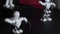 Humanoid robots with colourful illumination dancing.