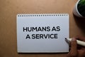 Humans As A Service write on a book.  on Wooden Table Royalty Free Stock Photo