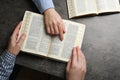 Humble couple reading Bibles at grey table together, top view Royalty Free Stock Photo