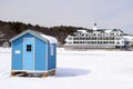 An ice fishing shack and a luxurious Hotel Royalty Free Stock Photo