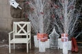 Santa chair near white trees and boxes with presents