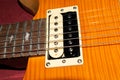 Humbucker pickup on a PRS SE Santana electric guitar in yellow product shot