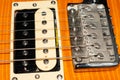 Humbucker pickup on a PRS SE Santana electric guitar in yellow product shot