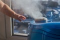 Humidifier producing a vapor with a baby`s hand Royalty Free Stock Photo