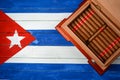 Humidor with cigars over Cuban flag background Royalty Free Stock Photo