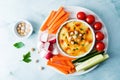 Hummus appetizer with carrot, radish, tomato and cucumber