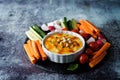 Hummus appetizer with carrot, radish, tomato and cucumber