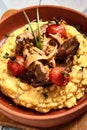Hummus with beef served in brown bowl