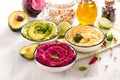 Hummus, colorful different dips, vegan snack, beetroot and avocado hummus, vegetarian eating Royalty Free Stock Photo