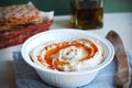 Hummus dip with olive oil and crisp bread basket Royalty Free Stock Photo