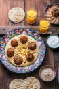 Hummus with falafel and pita in traditional plate