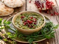 Hummus. Herbal hummus with the addition of pomegranate seeds, parsley, olive oil and aromatic spices in a ceramic pot on a wooden Royalty Free Stock Photo