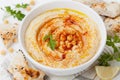 Hummus or houmous, appetizer made of mashed chickpeas, tahini, lemon, garlic, olive oil, parsley and paprika Royalty Free Stock Photo