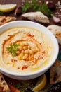 Hummus or houmous, appetizer made of mashed chickpeas, tahini, lemon, garlic, olive oil, parsley and paprika