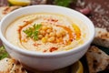 Hummus or houmous, appetizer made of mashed chickpeas, tahini, lemon, garlic, olive oil, parsley and paprika