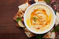 Hummus or houmous, appetizer made of mashed chickpeas, tahini, lemon, garlic, olive oil, parsley and paprika Royalty Free Stock Photo