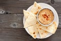 Hummus with pita bread on a plate, above view over wood Royalty Free Stock Photo