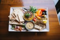 hummus platter with assorted dips and whole grain crackers