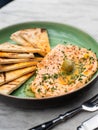 Hummus with spicy herbs, olive oil and cakes, traditional Eastern food Royalty Free Stock Photo