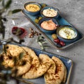 Hummus, Tzatziki served with pita bread. Greek and Mediterranean dips and spreads. Traditional classic Turkish and Greek