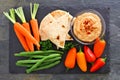 Hummus vegetable platter, above view on slate Royalty Free Stock Photo