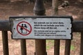 Humoristic sign in french and english located near an animal park. Do not feed animals with children. Royalty Free Stock Photo