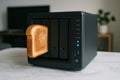 Toaster and computer storage device combine in a humorous scene with toasted bread Royalty Free Stock Photo