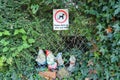 Humorous group of garden gnomes and a sign to clean up dog mess seen in a garden in the village of Nether Stowey in Somerset