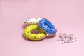 Humorous imitation of donuts from colored bagels with multi-colored pins