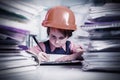 Humorous photo of young female engineer architect drawing on architectural project. Selective focus on eyes. Horizontal image Royalty Free Stock Photo