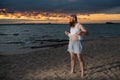 Humorous portrait of a brutal man posing on the beach at sunset Royalty Free Stock Photo