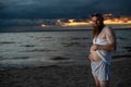 Humorous portrait of a brutal man posing on the beach at sunset Royalty Free Stock Photo