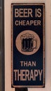 Humorous sign stating that `Beer is cheaper than therapy on a wall in a restaurant in Portugal.