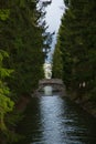 Humpback bridge over the water channel in the park. Royalty Free Stock Photo