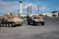 View of a Humvee passing the side of an FMC A113 Armored Military Vehicle