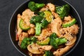 Hunan Chicken in black bowl at dark slate background. Chinese or indo-chinese cuisine takeaway dish Royalty Free Stock Photo