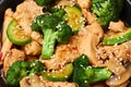 Hunan Chicken in black bowl at dark slate background. Chinese or indo-chinese cuisine takeaway dish