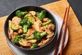 Hunan Chicken in black bowl at dark slate background. Chinese or indo-chinese cuisine takeaway dish Royalty Free Stock Photo