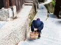 hunched old woman on street in Chengyang village