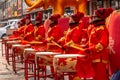 Women in red golden outfits drumming during the ceremonial of the opening of a store in Hunchun city of China, Jilin